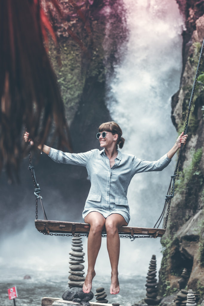 Calidad de Vida 1 Canva Woman Sitting on Swing Chair With Waterfalls Background